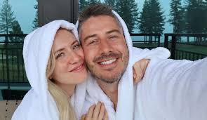 Arie Luyendyk Jr. and Lauren Burnham take a selfies in matching white onesies