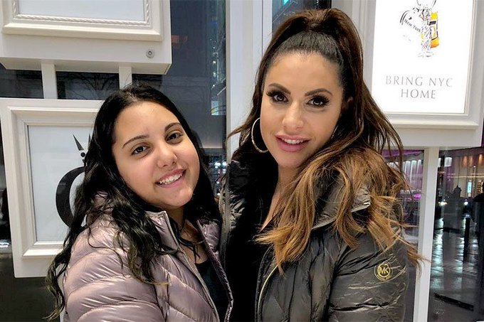 Jennifer Aydin and daughter wear winter coats.