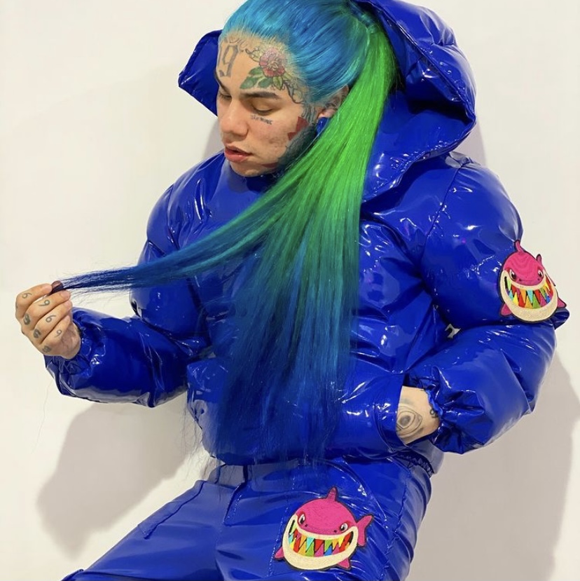 6ix9ine showing off his blue outfit and rainbow hair.