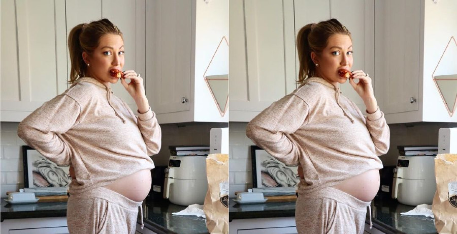 Stassi showing off her baby bump while eating a piece of chicken