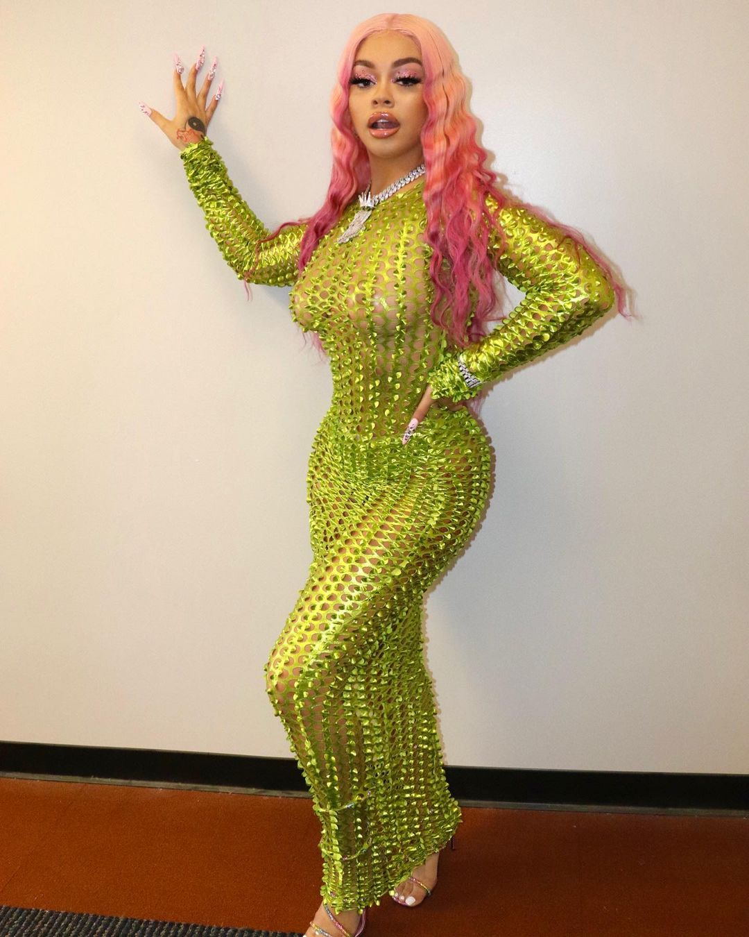 A lovely photo showing Mulatto in a sparkly see-through green dress that leaves nothing to imagination.