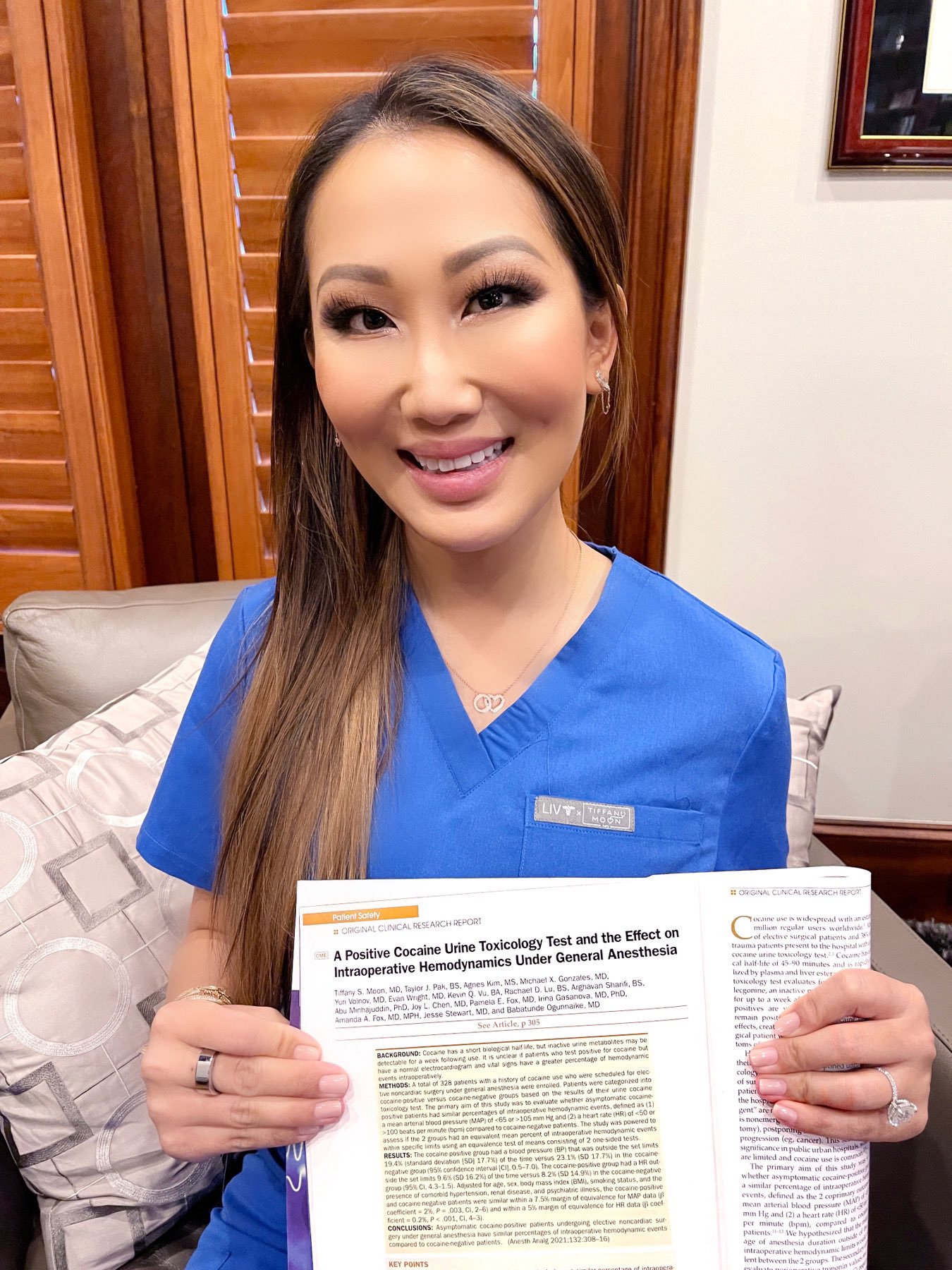 Dr. Tiffany Moon wears blue scrubs with straight hair.