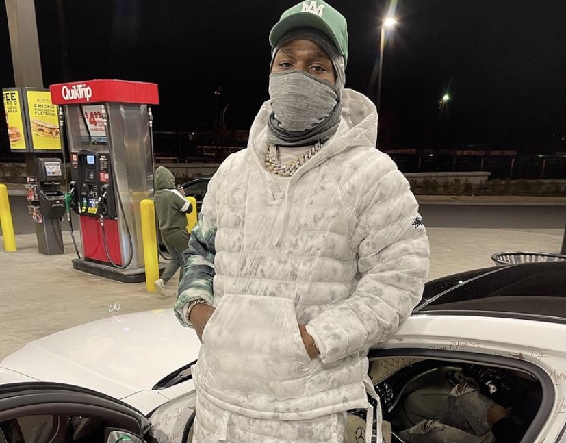 DaBaby posing at a gas station.