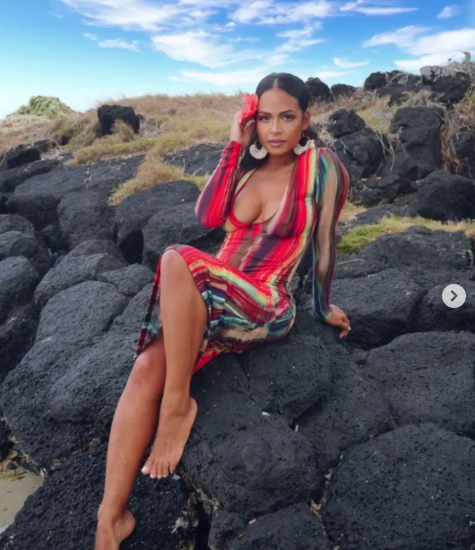 Christina Milian poses on rocks in a dress