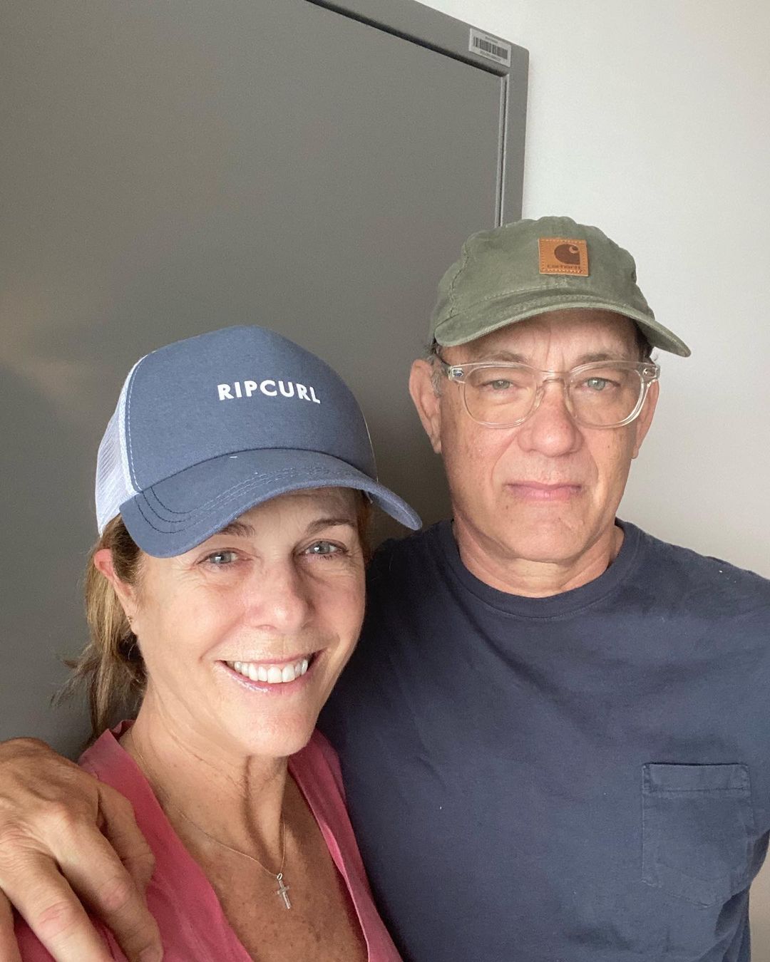 Tom Hanks and Rita Wilson pose for the camera in casual outfits at home. 