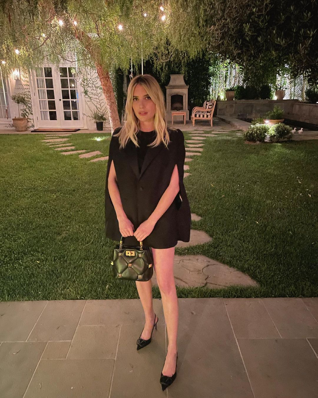 A photo of Emma Roberts in a black dress out for a date night.