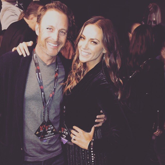 Jana Kramer has her arm around Chris Harrison.