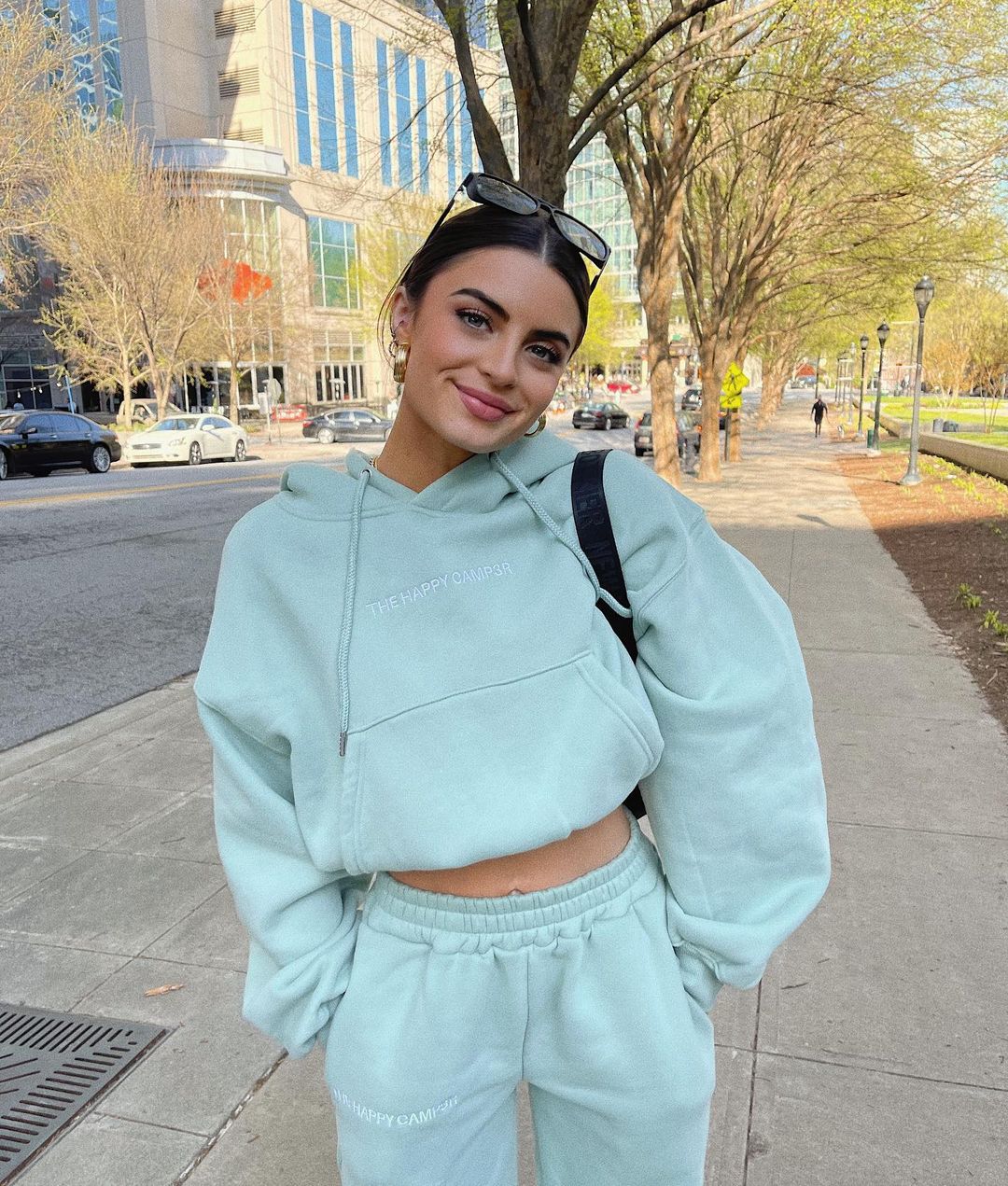 A photo showing Rachael Kirkconnell sporting a blue-green two-piece outfit during a lete afternoon stroll.