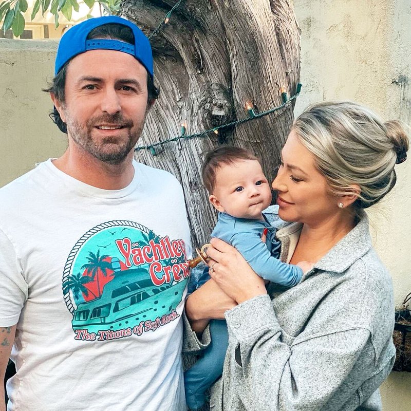 Stassi Schroeder holds daughter Hartford in a blue onesie.