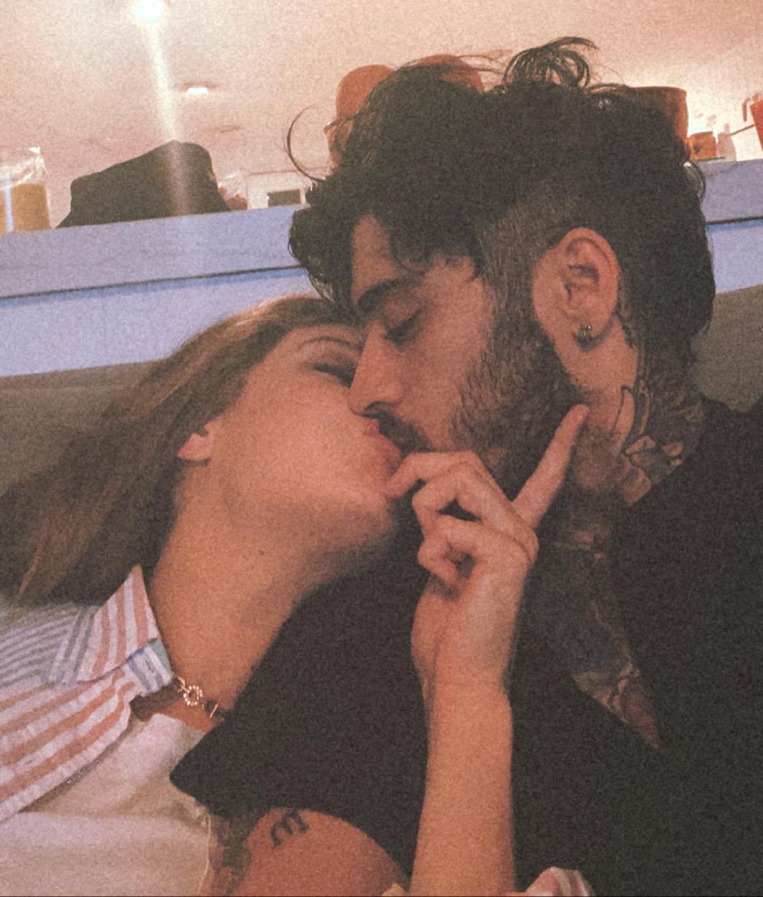 A photo of Gigi Hadid and Zayn Malik kissing.