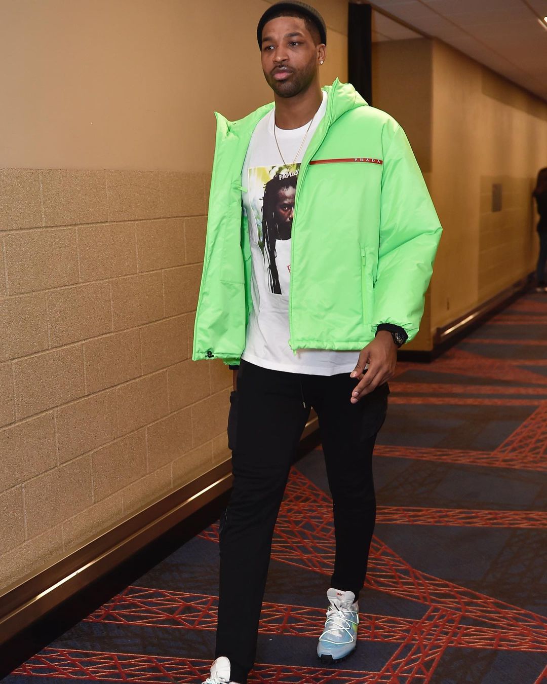 A photo showing Tristan Thompson sporting a green jacket and black pant. 