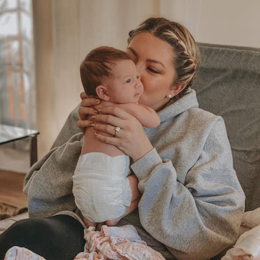 Stassi Schroeder holds daughter Hartford with her hair in braids.