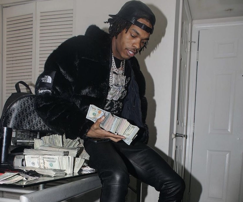 Lil Baby with his stacks of money.