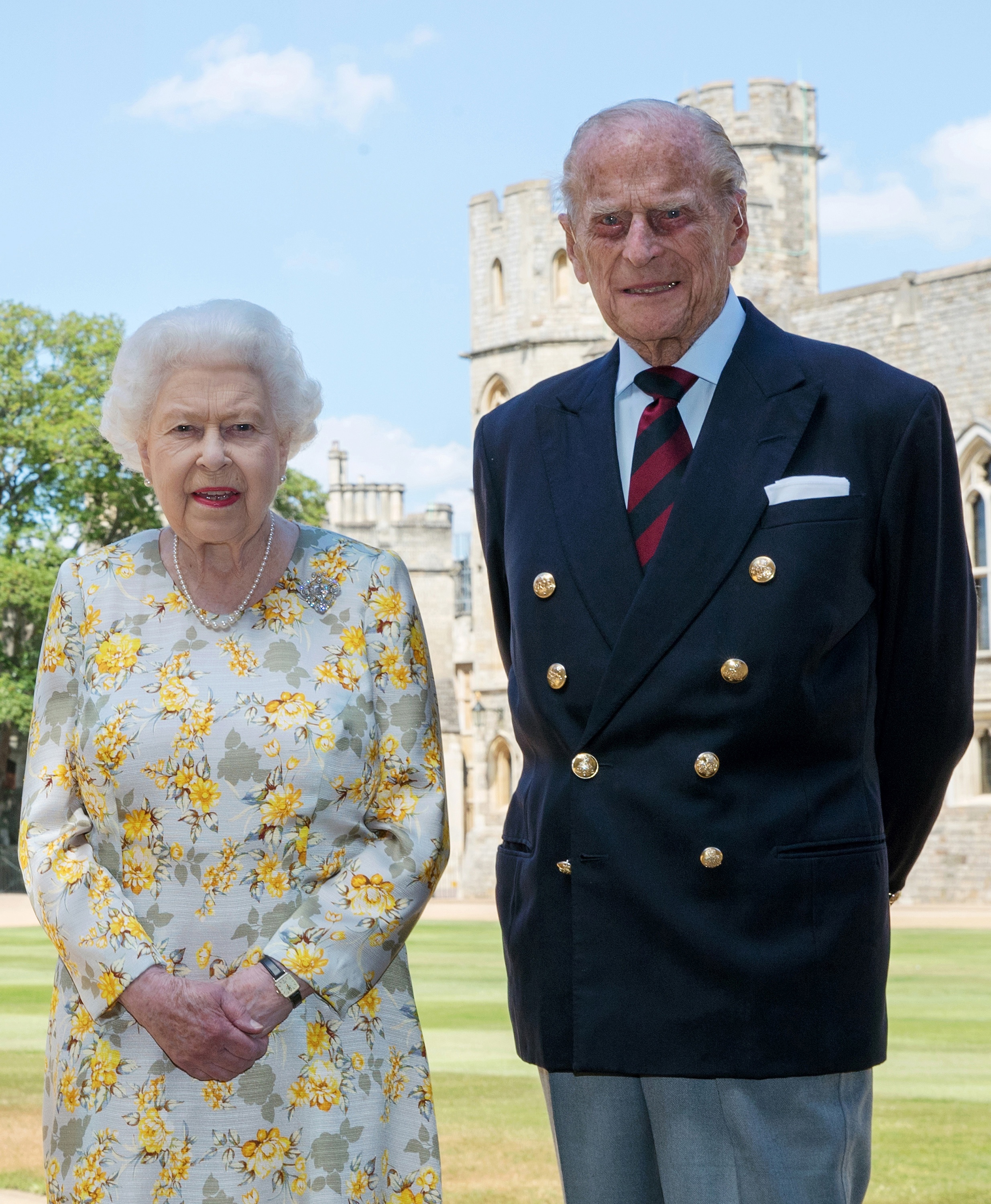 A photo showing Queen Elizabeth II and her now alte husband, Prince Philip posing for a photograph on a large green field.