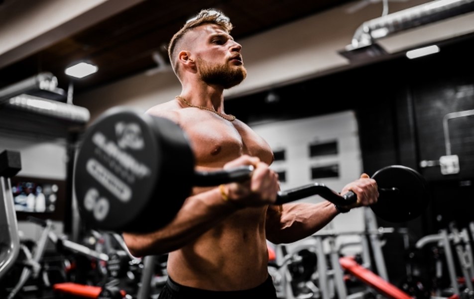 Athlete performing a barbell biceps curl