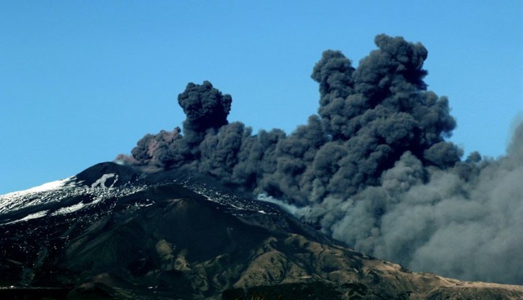 Aerial view of Mount Etna with ash plume.