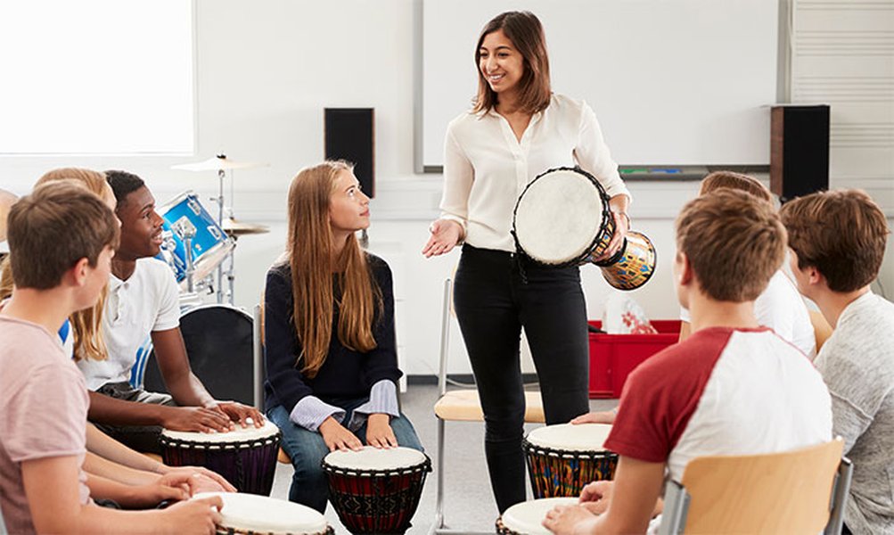 Music teacher giving a drum lesson
