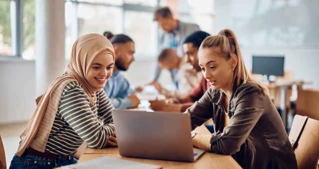 students in classroom engaging with business learning materials