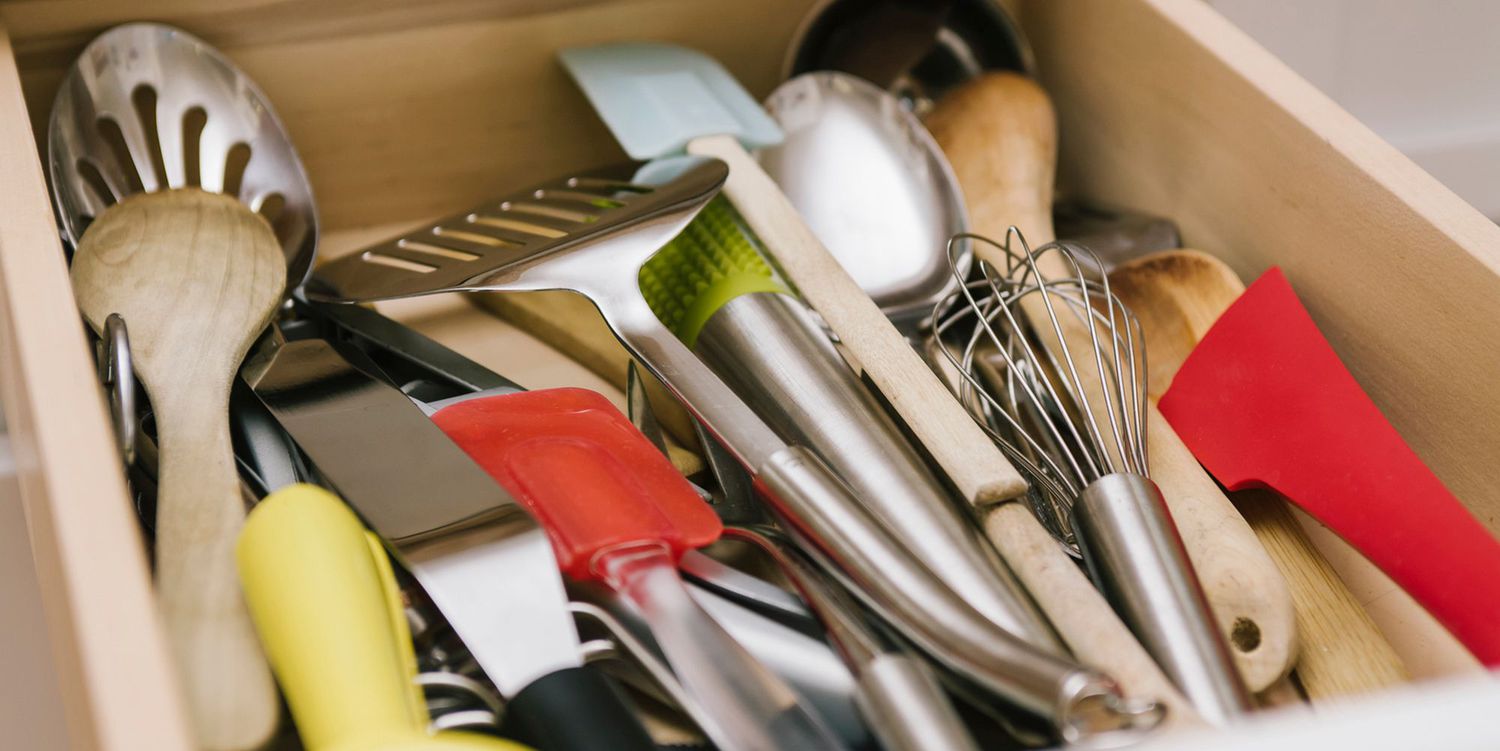 kitchen utensils and recipes on table