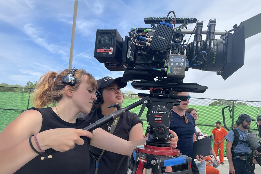 Students filming on a set, representing the video production process