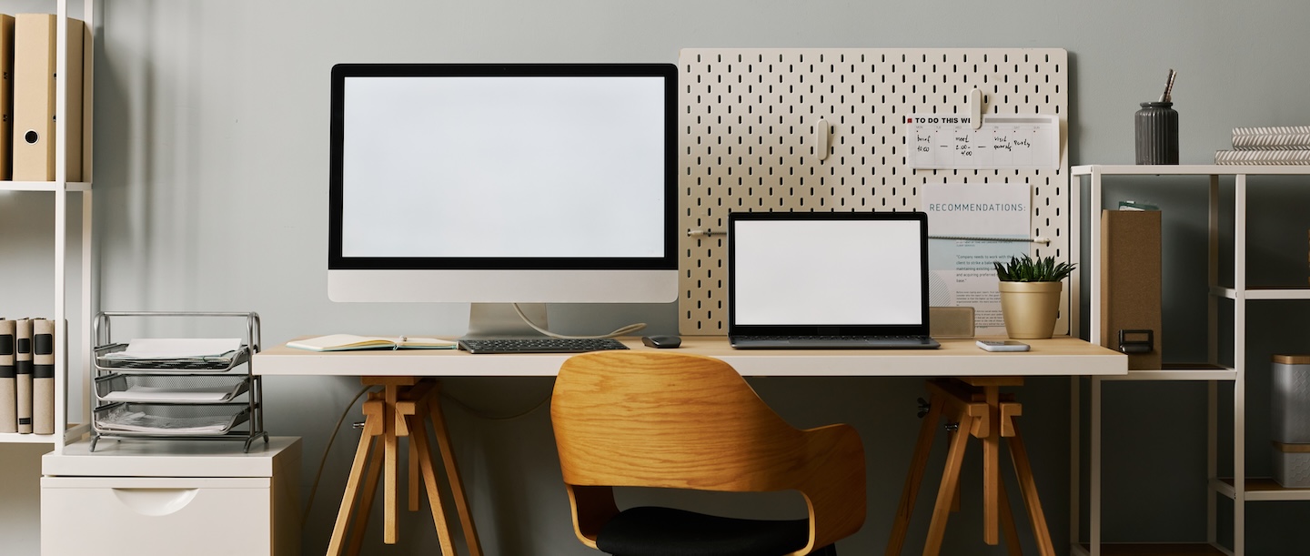 office workspace with tax documents and digital display