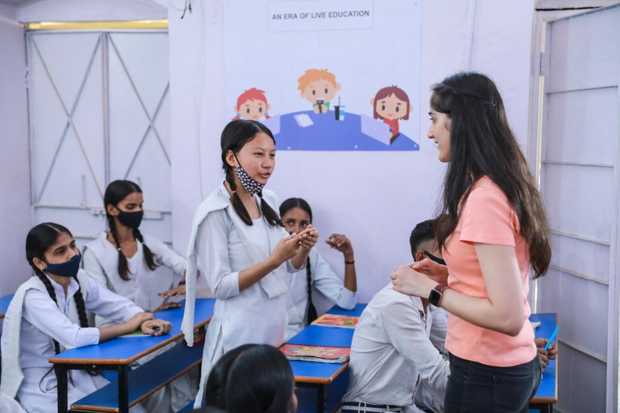 Image of students learning coding in a classroom with Amazon employees