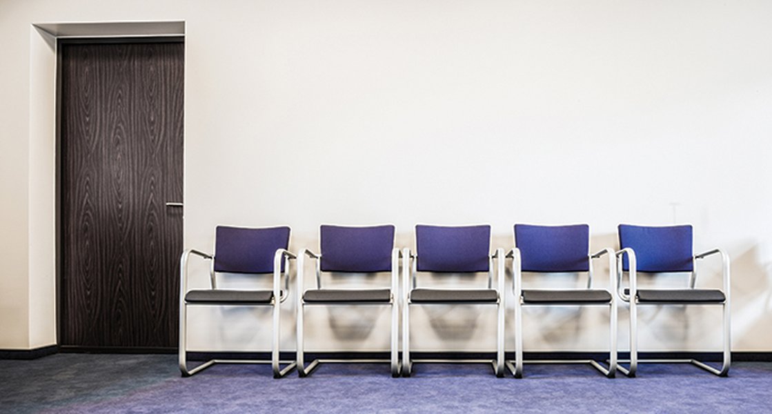 Empty chairs in a waiting room, symbolizing the wait for candidates or decisions