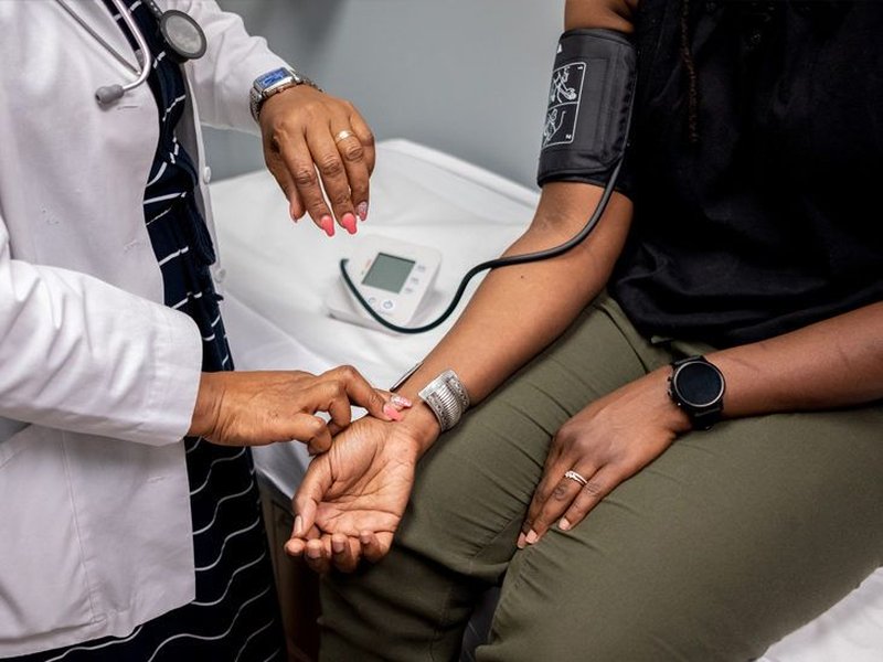 Doctor checking a patient's blood pressure