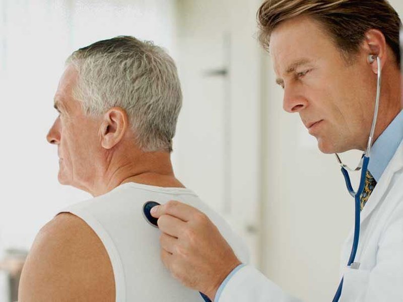 Doctor listening to a patient's lungs with a stethoscope