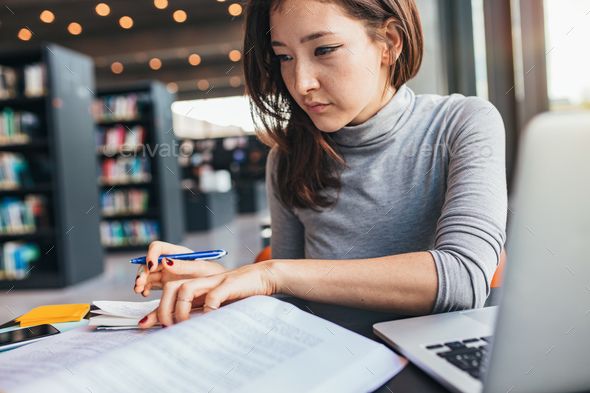 person studying with computer books