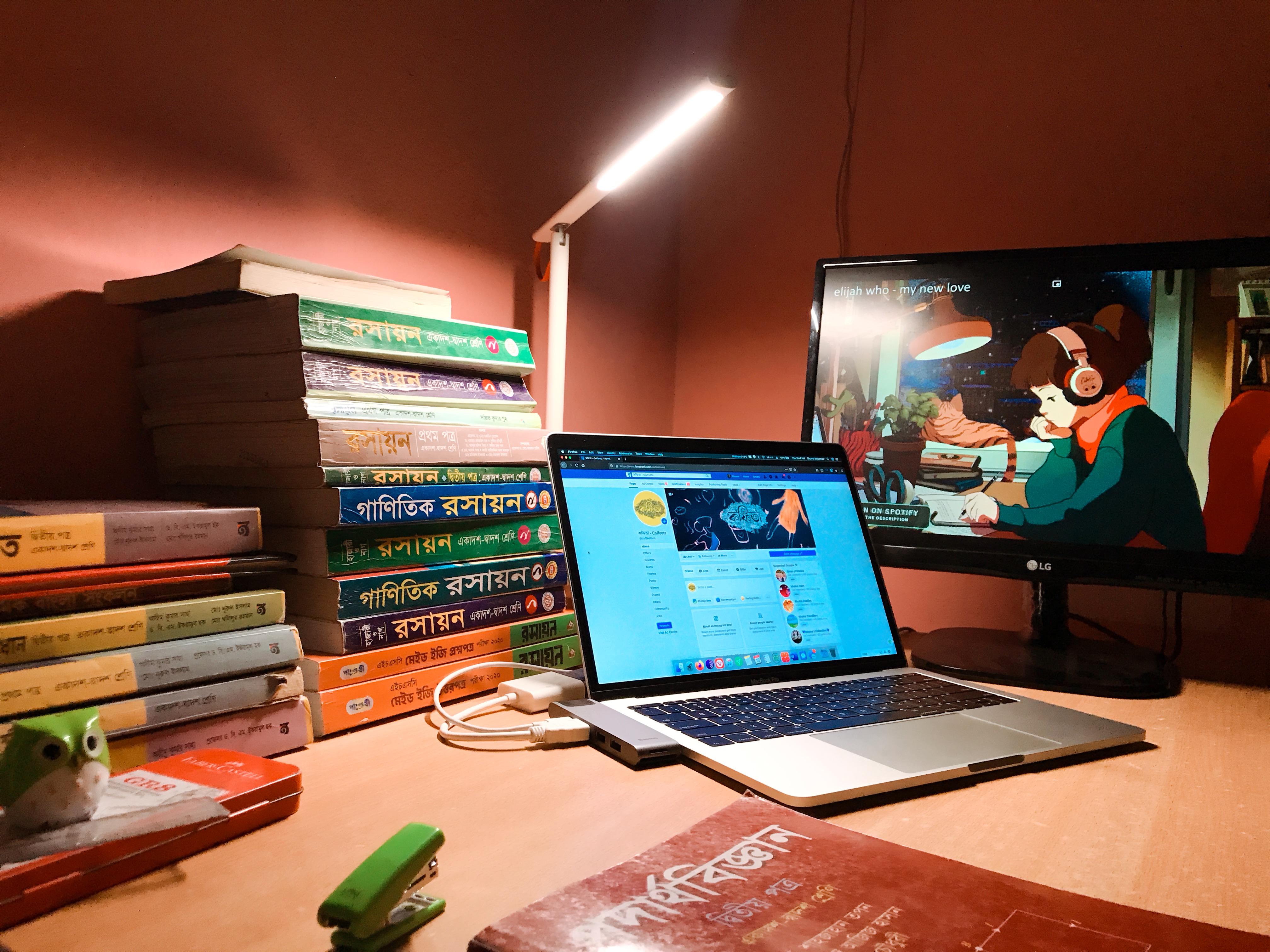 academic desk setup with books and laptop