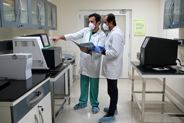 researchers working in a laboratory with sequencing equipment