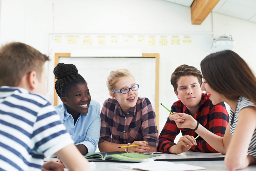 students practicing conversation in a classroom