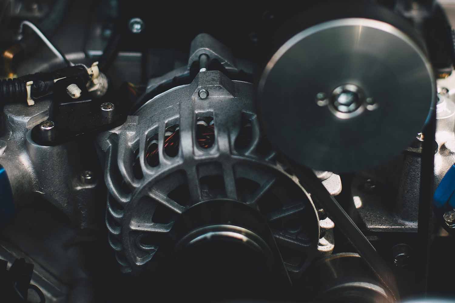 close up of car battery and alternator
