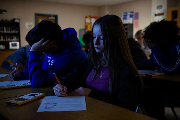 students studying in a classroom at dusk