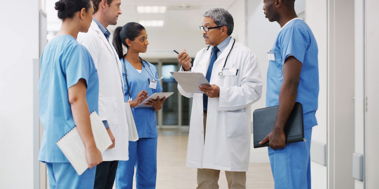 healthcare professionals discussion in hospital corridor