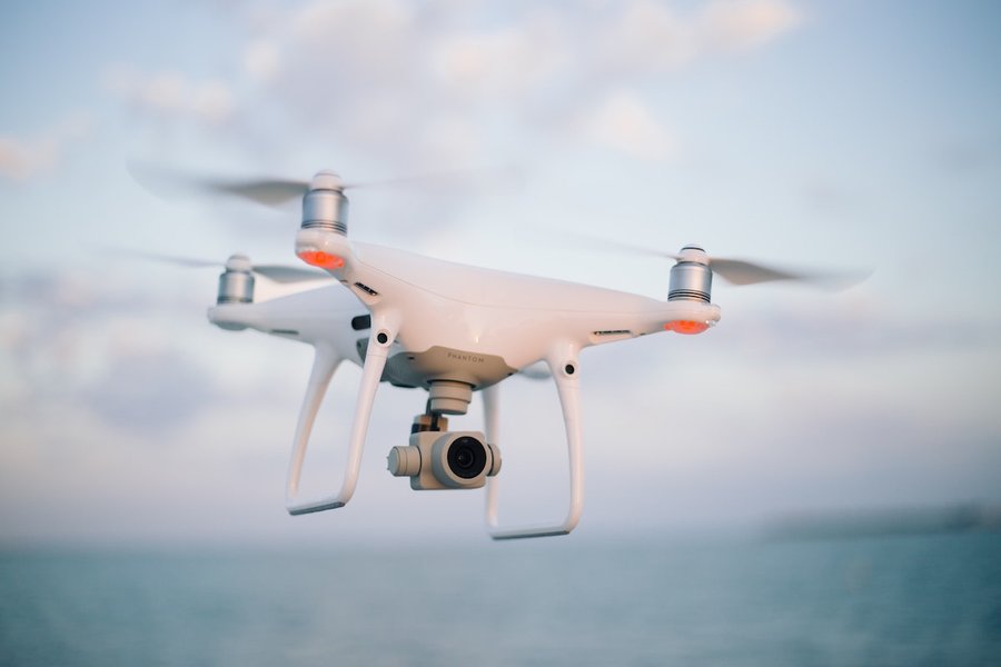 Drone flying over a landscape, potentially for delivery or surveillance