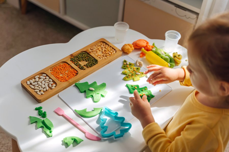 Preschooler engaged in a STEM activity with colorful materials