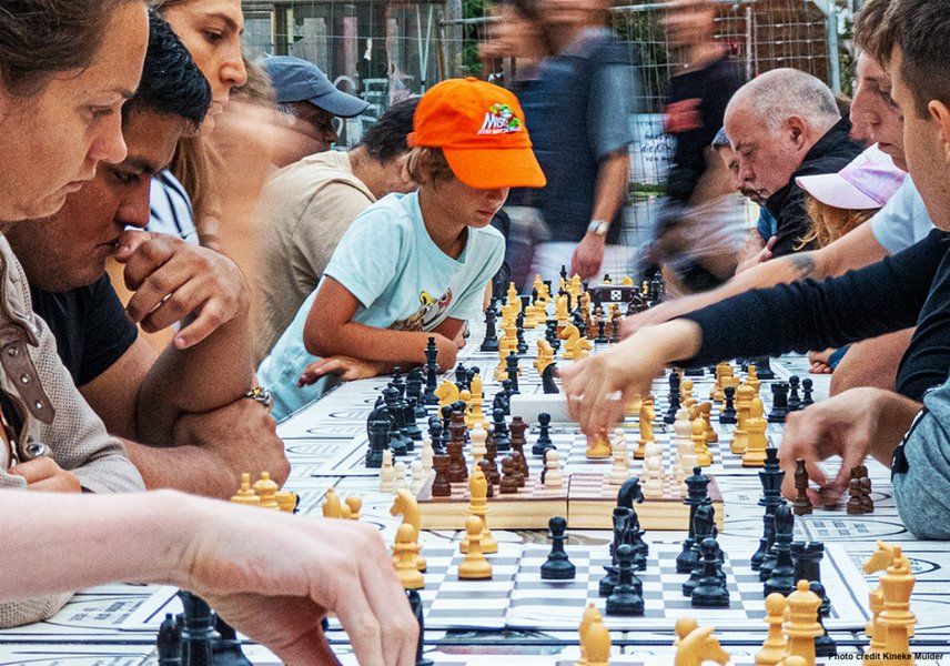 People playing chess outdoors in a public space