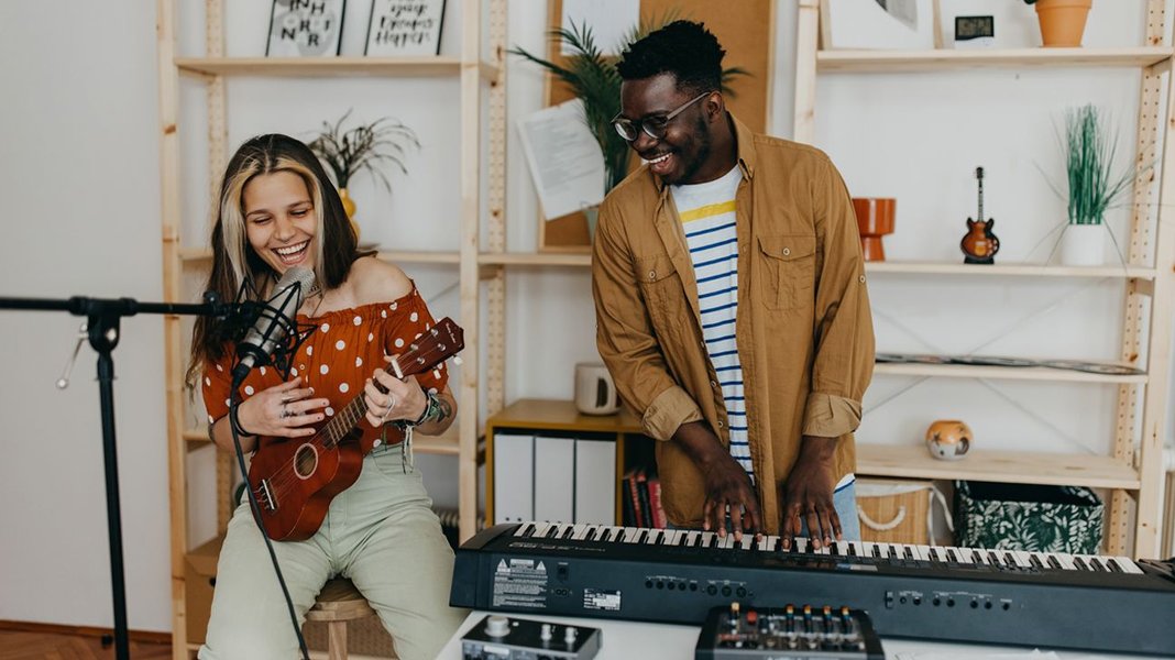 Two people happily playing musical instruments together