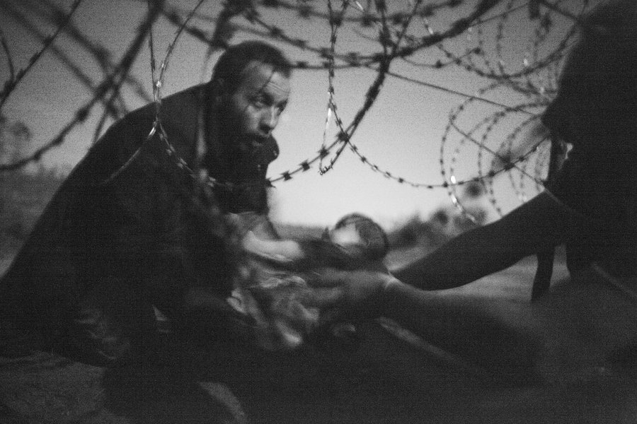 People crossing a border, suggesting migration and displacement