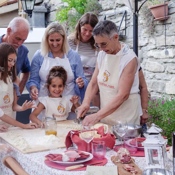 Niños participando en una clase de cocina en la Toscana.