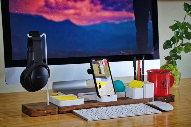 modern desk setup with laptop and notes