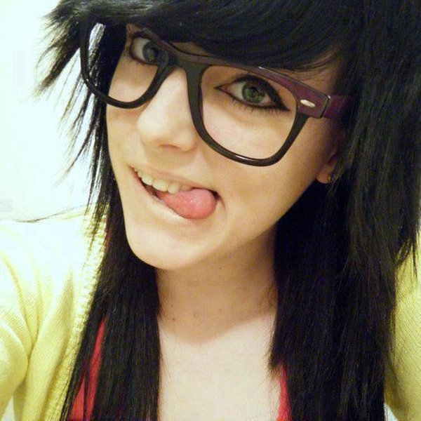 A close-up of thick, black-rimmed glasses, a hallmark of the emo and bookworm aesthetic.