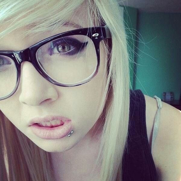 A woman with dark hair and glasses, representing the bookworm emo aesthetic.