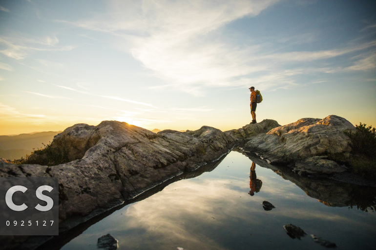confident person standing on mountain top