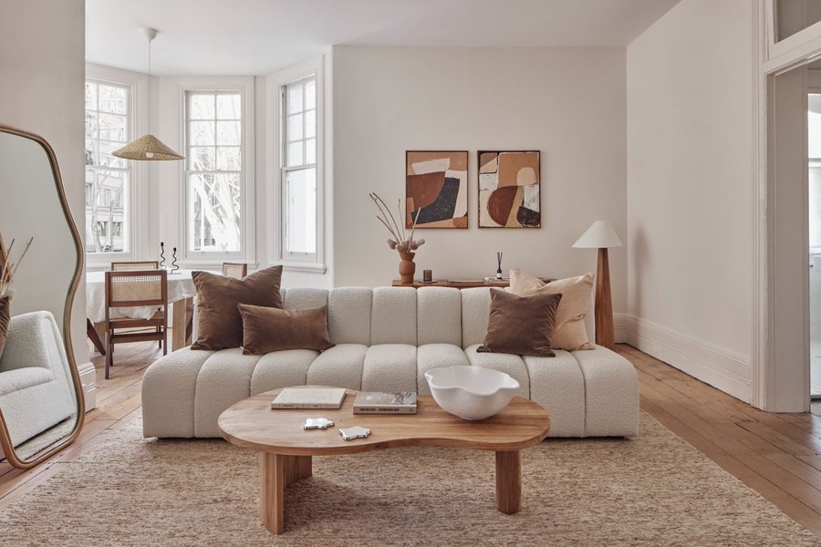 A cozy living room with a bouclé sofa, enhancing the warm ambiance.