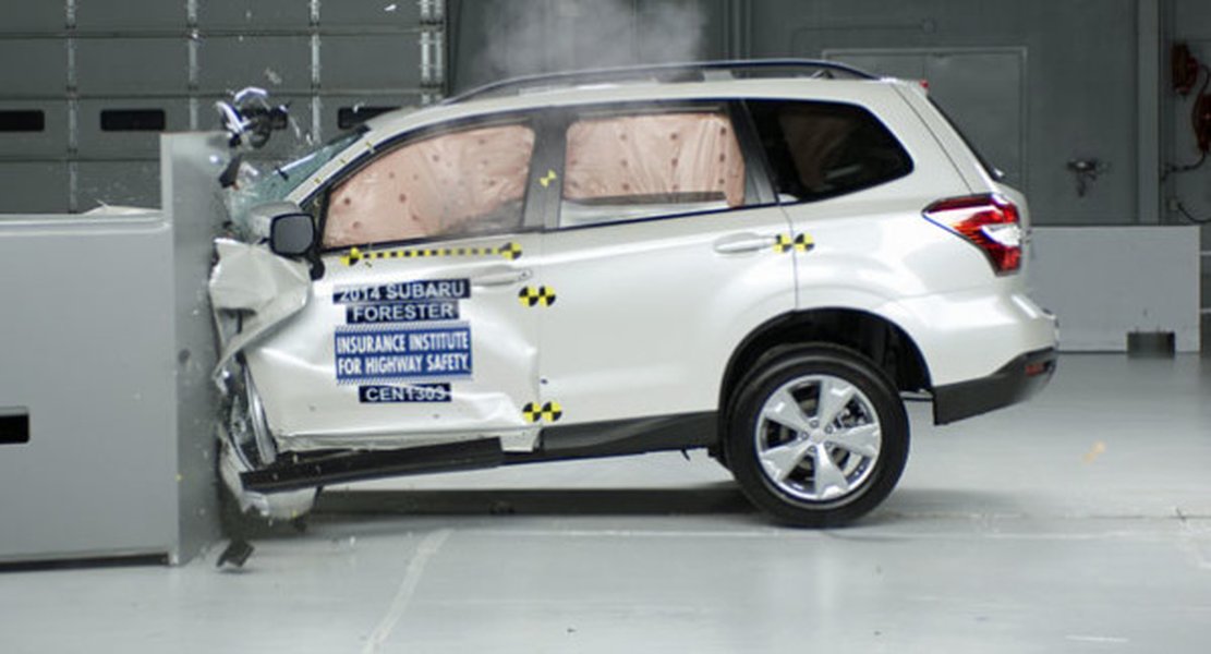 Car undergoing a frontal offset crash test against a deformable barrier