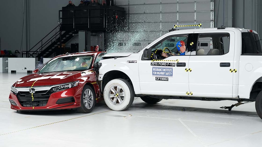 Vehicle undergoing a side impact test with a movable barrier