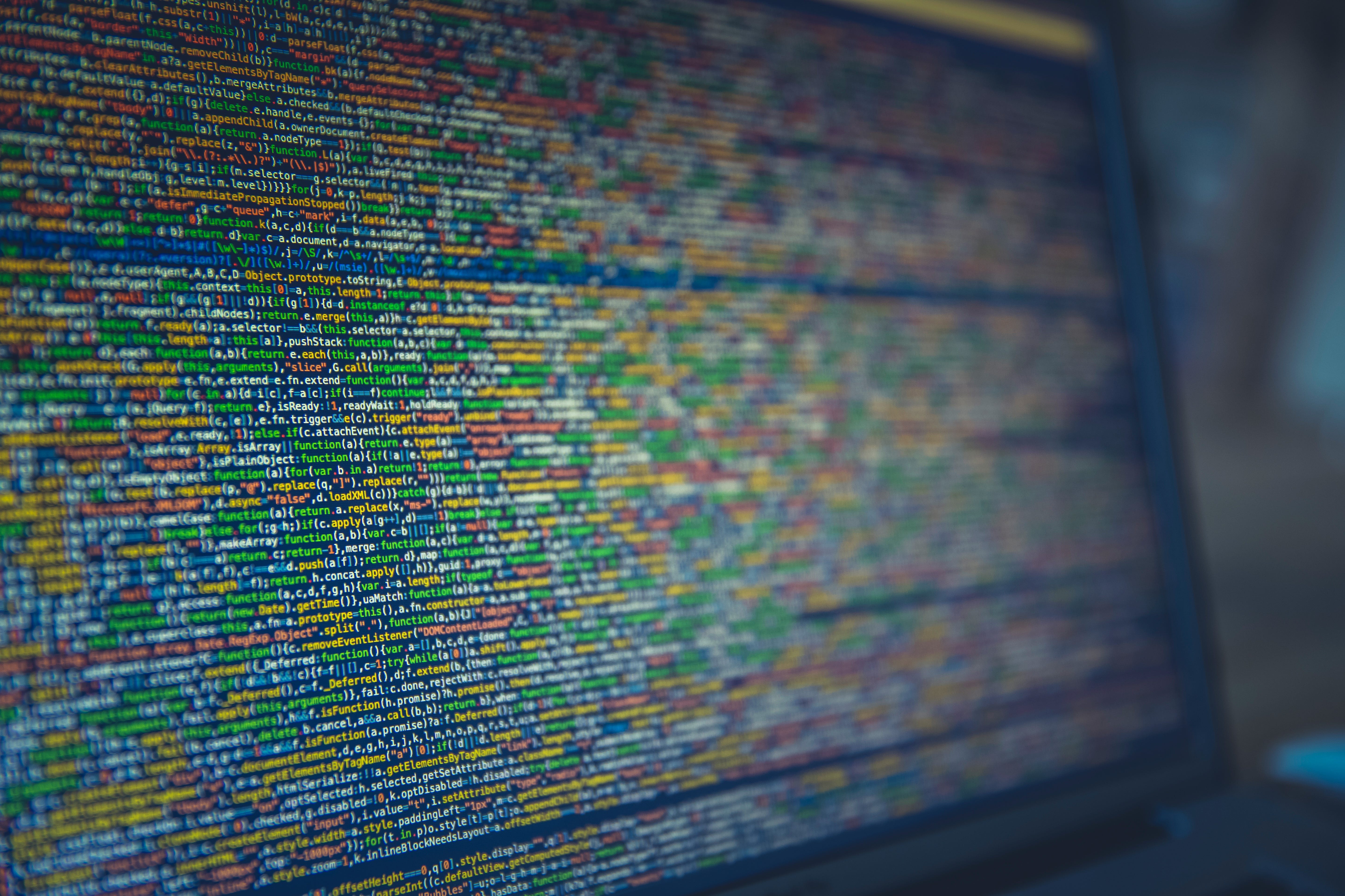 desktop computer displaying C code on screen